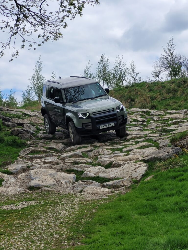The Habitat Works team navigating difficult terrain in a Land Rover Defender